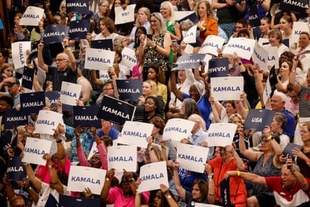 people hold signs reading kamala