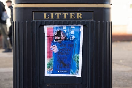 Printed picture of person accused of removing flags. Face has been etched out.
