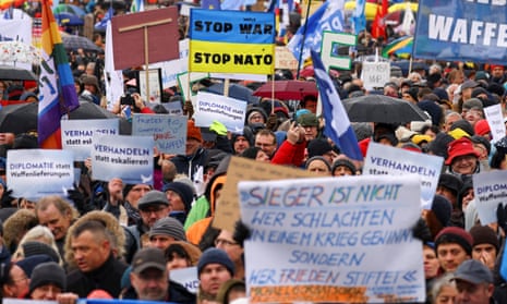 People take part in a protest against the delivery of weapons to Ukraine, and in support of peace negotiations, in Berlin, Germany.