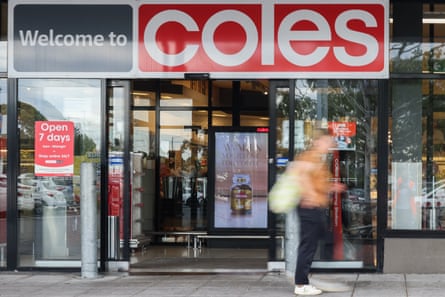 A customer walks past a Coles supermarket on March 19, 2024 in Melbourne, Australia