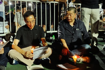 Martin Lee, left, the founding chairman of the Democratic party in Hong Kong, sits beside Jimmy Lai in 2015 in Victoria Park at a candlelit vigil to mark the anniversary of the 1989 Tiananmen Square crackdown.