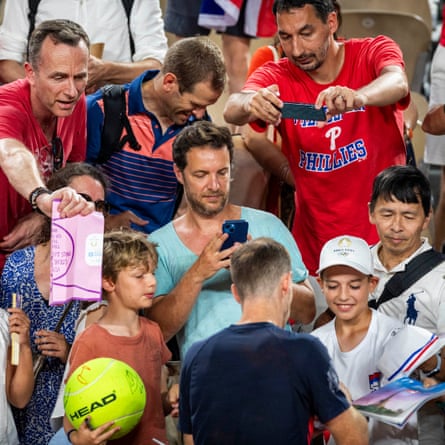 Andy Murray signs autographs after he and Dan Evans of Britain won their men’s doubles tennis second round match against Belgium’s Sander Gille and Joran Vliegen.