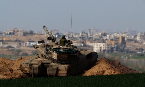 An Israeli tank moves along the border with northern Gaza.