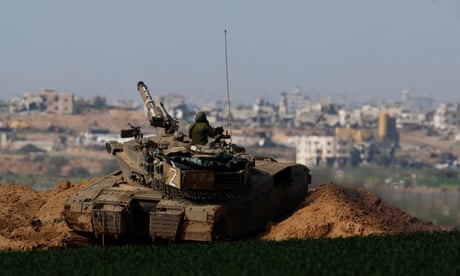 An Israeli tank moves along the border with northern Gaza.