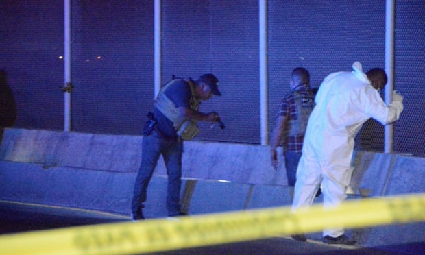 Police officers and a forensic technician work at the crime scene where a Mexican asylum seeker killed himself after being denied entry into the US at the Pharr-Reynosa international bridge on 8 January. 
