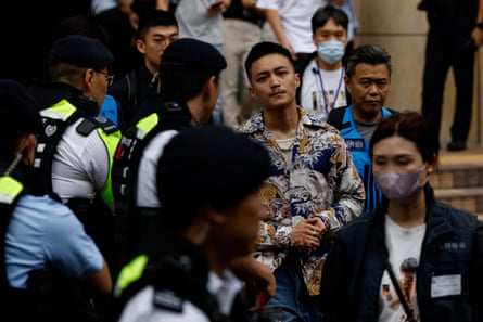 Lee Yue-shun outside court surrounded by officials