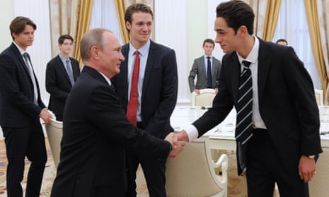 Putin shakes hands with an Eton schoolboy.