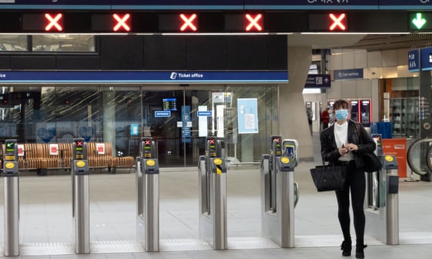 A rail user passes through the gates at London Bridge station