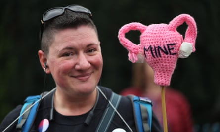A protester makes her point with the aid of a knitted uterus