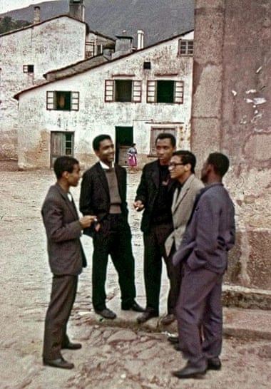 Making plans: five students enjoy a smoke after fleeing from Portugal.