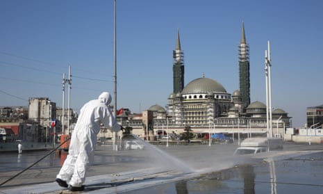 Workers clean and disinfect surfaces in Taksim Square, Istanbul.