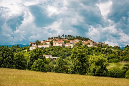 Hilltop village under a dramatic sky.