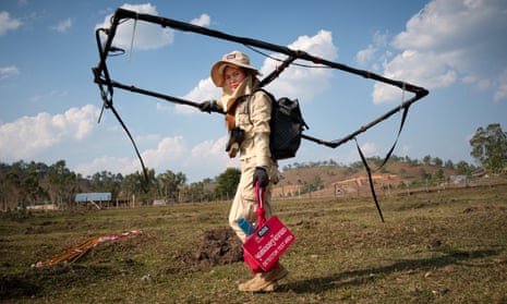 A bomb-clearance technician from the Mines Advisory Group holds an Erbinger Large Loop detector, Xieng Khoung, Laos.