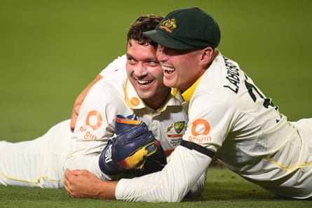 Alex Carey celebrates with Marnus Labuschagne after a brilliant catch to dismiss Gus Atikinson.
