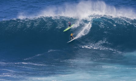 Laura Enever, upper left, and Felicity Palmateer, both of Australia, ride a wave at a Maui surf break known as Jaws.