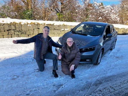 Sam Wollaston and Harald Nils Røstvik posing for a photo by an electric car