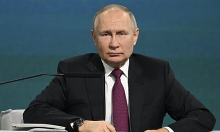 Vladimir Putin seated onstage