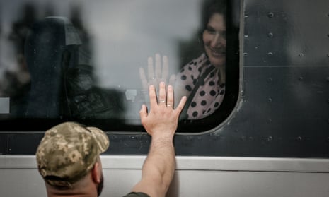 A couple bid each other farewell through a train window at the railway station in Kramatorsk, Donetsk.