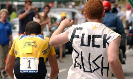 A fan wearing a T-shirt reading 'Fuck Bush' runs after Lance Armstrong in the Tour de France.