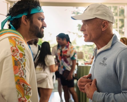 An ageing sportsman remonstrating with a younger man.