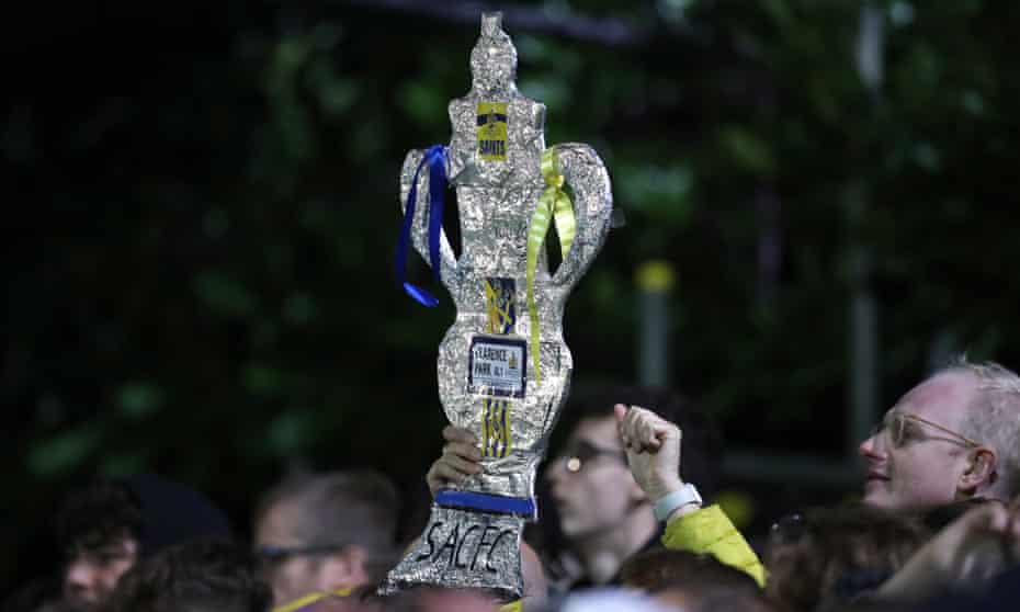 A foil replica FA Cup trophy in the crowd at St Albans City's first-round tie with Forest Green Rovers at Clarence Park