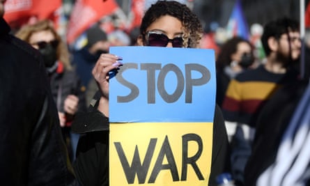 A demonstrator holds sign during a protest in Rome.