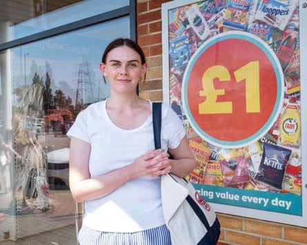 Woman standing in front of Poundland poster