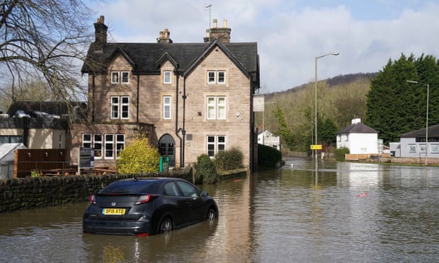 A stranded vehicle in flood water in Belper, Derbyshire