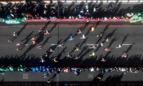 Competitors run over Tower Bridge as they compete in the 2021 London Marathon