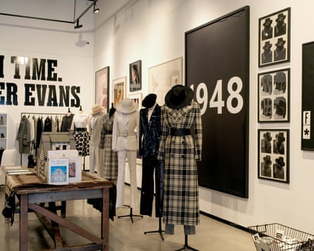 Gallery space with mannequins and art pieces hanging on wall