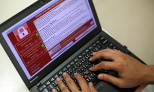 A programer shows a sample of a ransomware cyberattack on a laptop in Taipei.