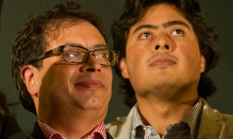 Nicolás Petro stands behind his father, Gustavo petro, as they look upwards