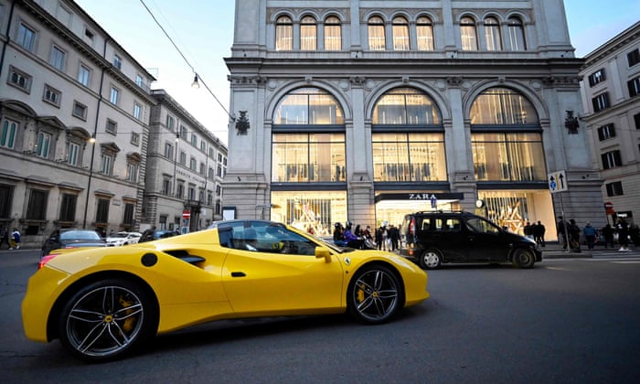 A Ferrari F8 Spider luxury car in downtown Rome.
