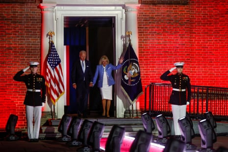 Joe Biden and Jill Biden walk out as military members salute.