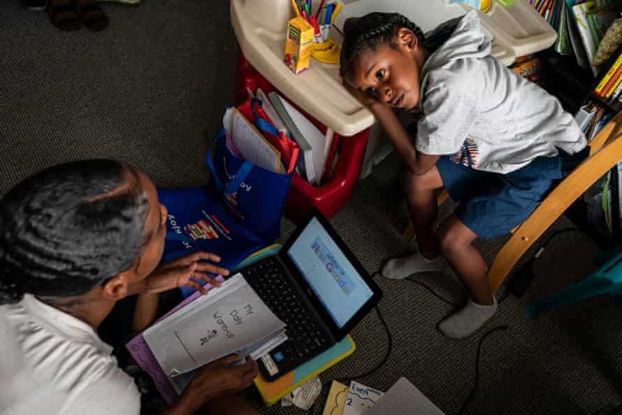 Cherokeena works with Mai’Kel on his distance-learning first grade homework in their private room in the transitional house that the organization Family Promise helped them find.