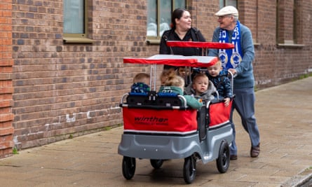 Ralph Barnes and Sam Mort, a nursery staff member, take a group of toddlers on a walk