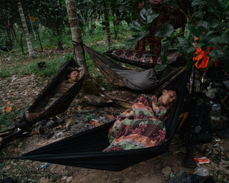 Fighters sleep in hammocks in the woods