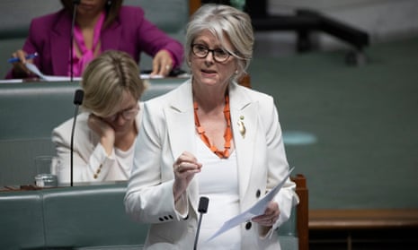 Woman wearing white jacket and top in parliament speaking