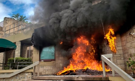 The entrance of the US embassy in Tegucigalpa burns after being set on fire by demonstrators of the education and health sectors protesting against government reforms, on 31 May.