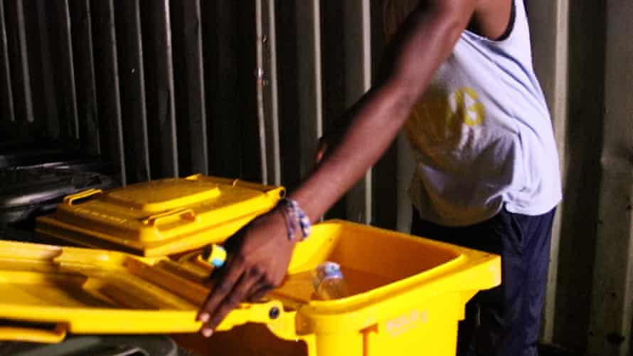 Men store water in bins at the Manus Island detention centre.