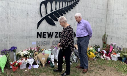 Dame Annette King and her husband, Ray Lind, look at flowers left outside the New Zealand high commission in Canberra