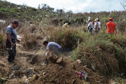 Searchers look for signs of clandestine graves inside a municipal dump in the port city of Veracruz on 11 March 2019.