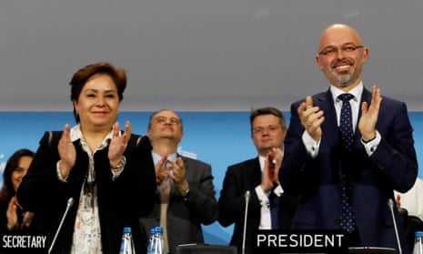 COP24 president Michal Kurtyka and UN climate chief Patricia Espinosa react after adopting the final agreement during the closing session of the conference in Katowice, Poland