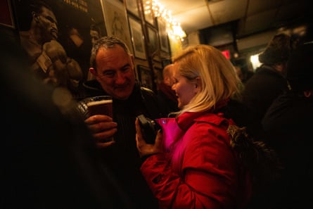 people squeeze past each other in a bar