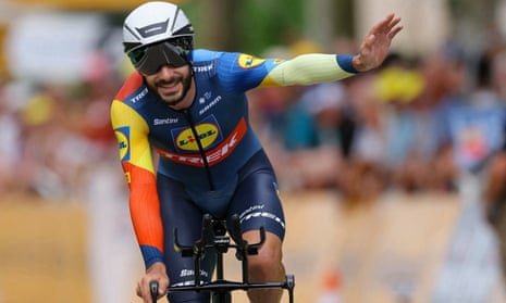 Julien Bernard waves to fans as he crosses the finish line.