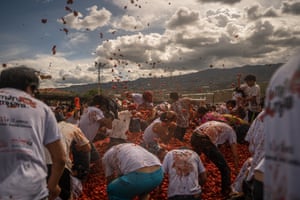 People celebrate and throw tomatoes at