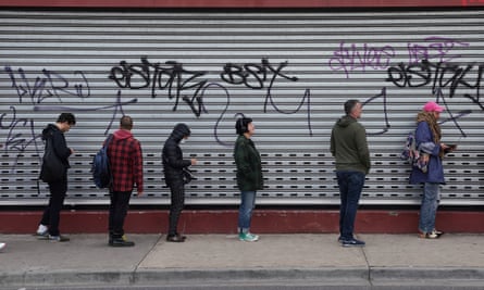 People queue outside a Centrelink office in Preston, Melbourne on 23 March 2020.