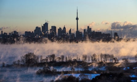Mist rises from Lake Ontario in front of the Toronto skyline during extreme cold weather.