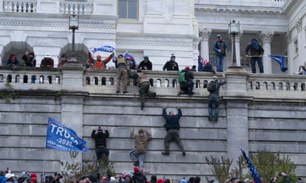 A mob of Trump supporters climb the west wall of the the US Capitol in Washington.