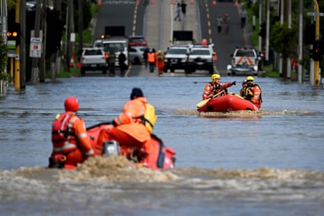 Emergency workers patrol a flooded area of Maribyrnong in Melbourne on Friday as floods hit Victoria, Tasmania and NSW